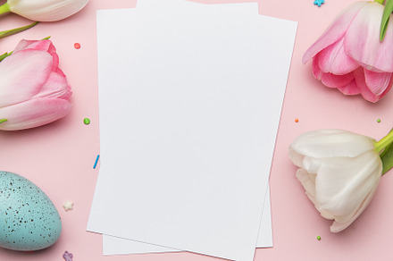 Easter greeting card mockup with colorful eggs and tulips on pin, a Photo by Olena Rudo