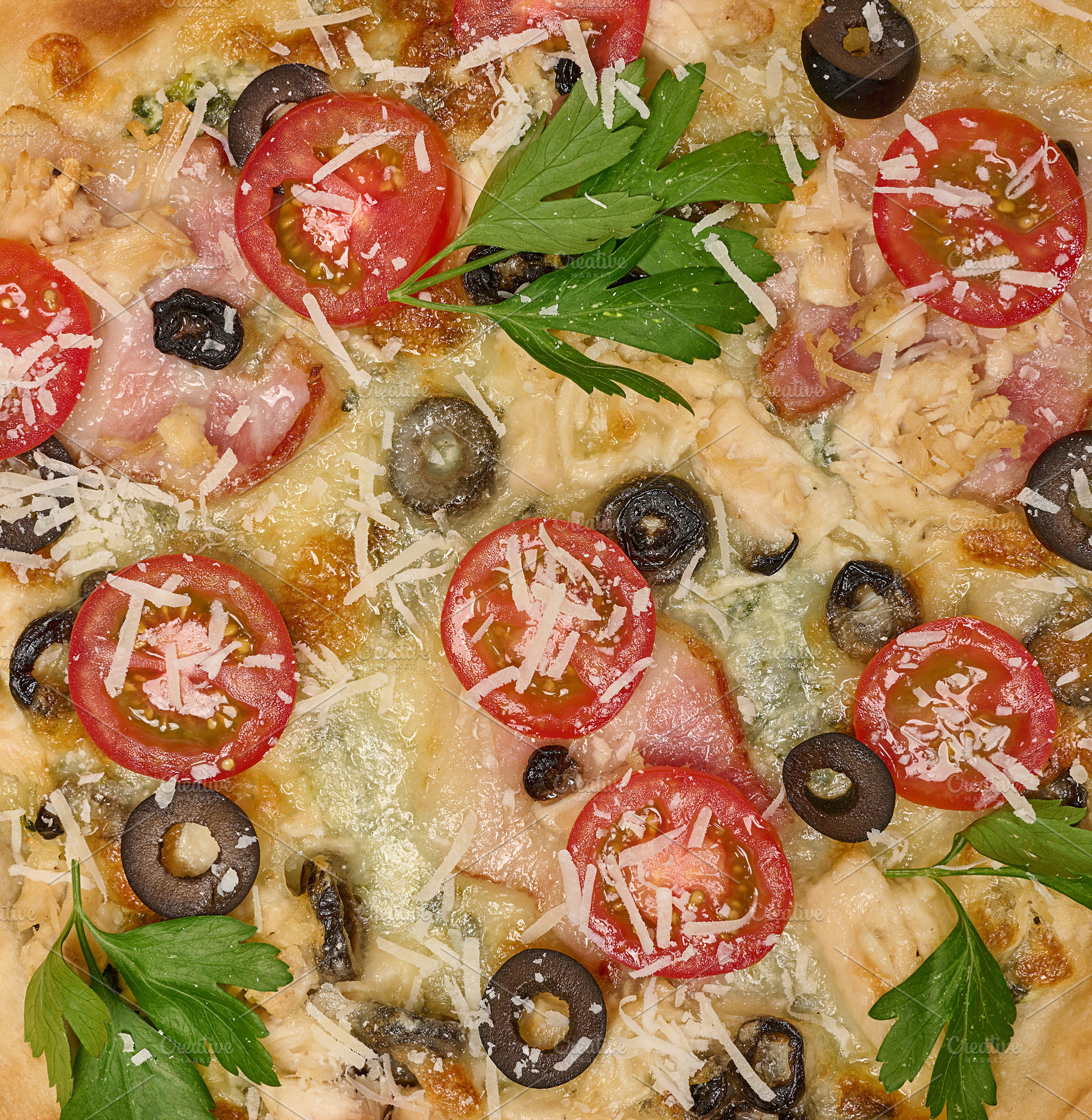 Close-up of delicious pizza with tomato, olive, bacon, chicken,, a Food & Drink Photo by ndanko