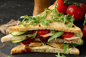 Grilled chicken sandwich with fresh tomatoes, cucumbers, arugula, a Food & Drink Photo by ndanko
