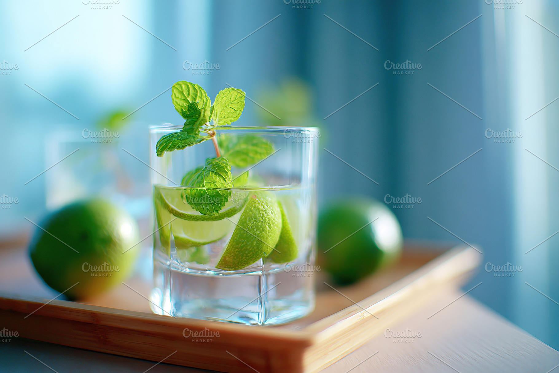 Refreshing mint and lime drink served in a glass on a wooden tray in bright ind, a Food & Drink Photo by AlyaAnd
