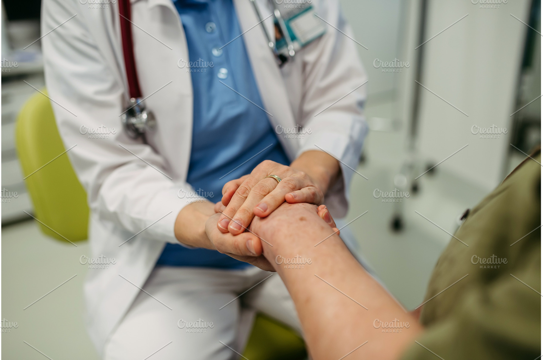 Caring doctor holding senior patient, a Health & Medical Photo by HalfPoint