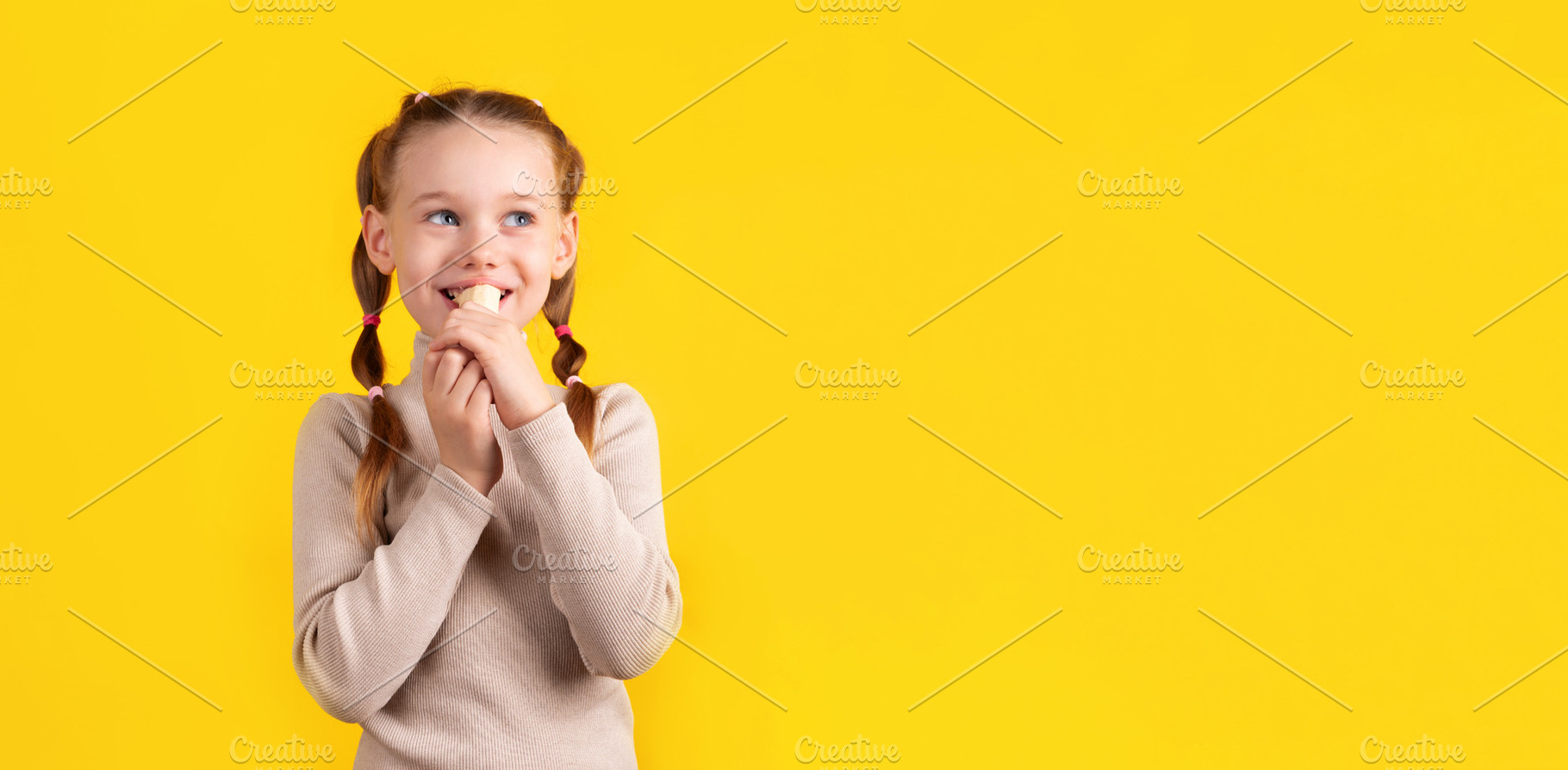 Happy young girl with pigtails eating a banana against a vibrant, a Person Photo by Ales Munt