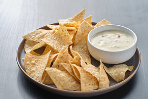 Queso blanco dip with chips containing food, queso blanco, and tortilla chips
