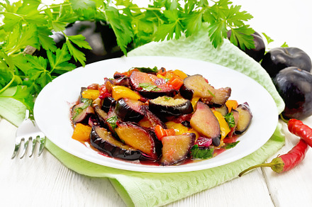 Eggplant with plums in plate