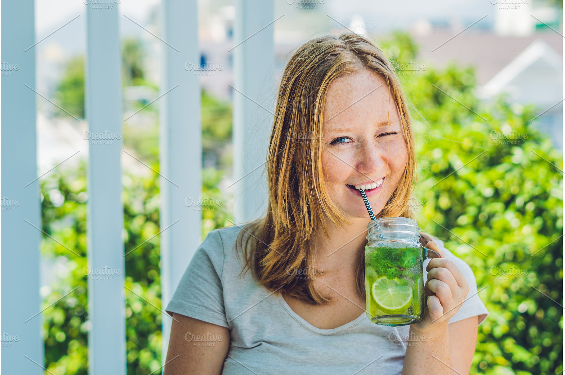 A young woman holds a mason jar in, a Person Photo by Elizaveta Galitskaya
