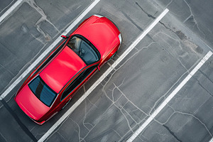 Aerial view of red car parked in the parking lot, a Transportation Photo by AlyaAnd