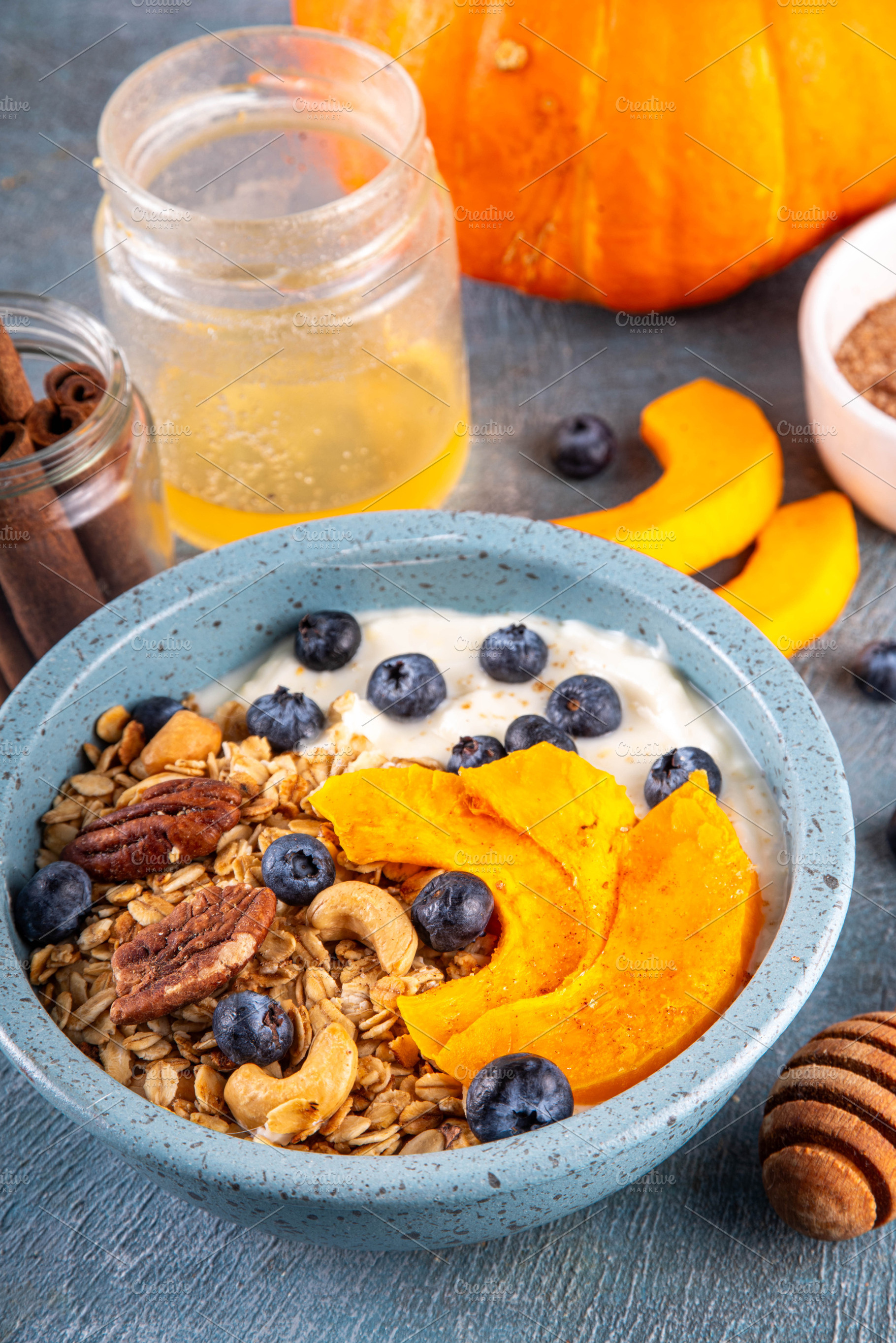Healthy autumn breakfast bowl with yogurt, granola, nuts, baked, a Food & Drink Photo by Rimma