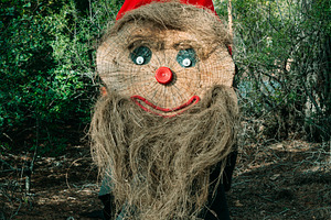 a tall Tio de Nadal with a long straw beard, a Photo by Nito
