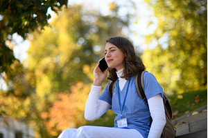 Beautiful nurse making phone call on, a Person Photo by HalfPoint