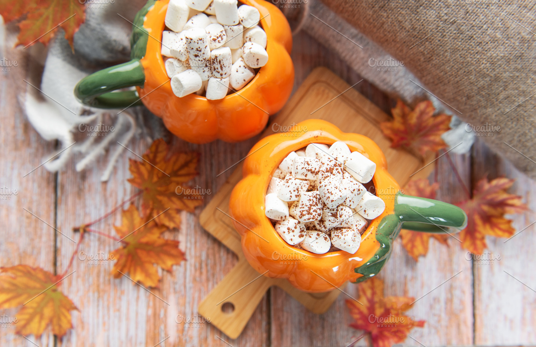 Pumpkin mugs filled with hot chocolate warming up for fall, a Food & Drink Photo by Olena Rudo