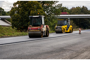 Two heavy asphalt road roller with, an Industrial Photo by volodymyrshtun13795
