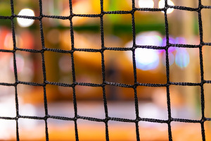 Close-up of a black net or mesh grid in sharp focus with a color, a Background Photo by Ales Munt
