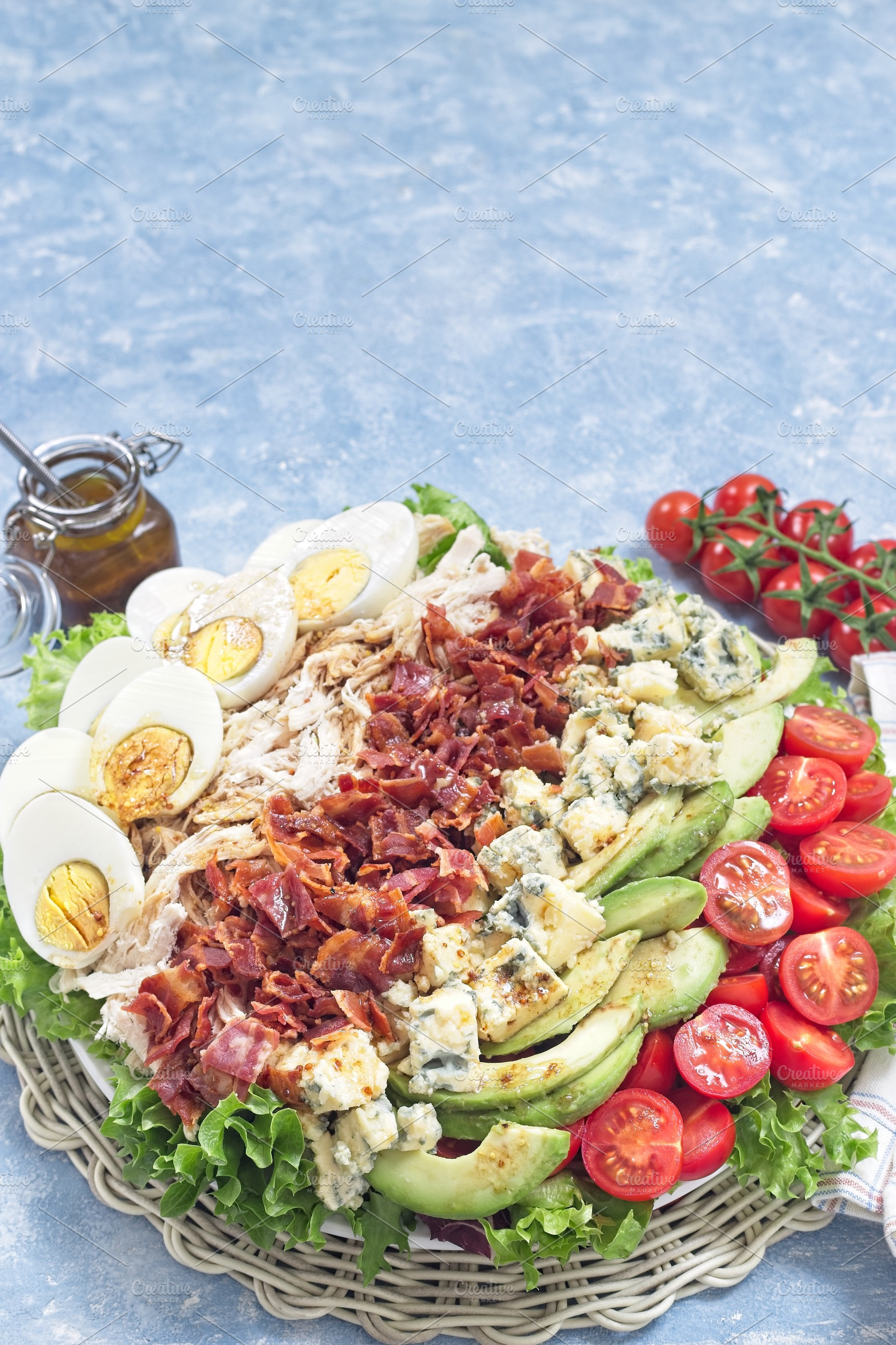 Delicious Cobb salad with greens, tomato, avocado, blue cheese, bacon, chicken, a Food & Drink Photo by iuliia_n