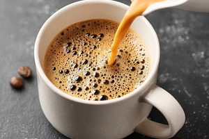 Pouring latte art into a coffee cup, a Food & Drink Photo by AlyaAnd