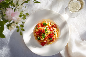 Fresh fettuccine pasta with cherry tomatoes and basil, serving a, a Photo by Studio ANNA