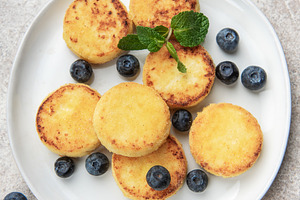 Homemade syrniki cottage cheese pancakes with blueberries and mi, a Food & Drink Photo by Olena Rudo