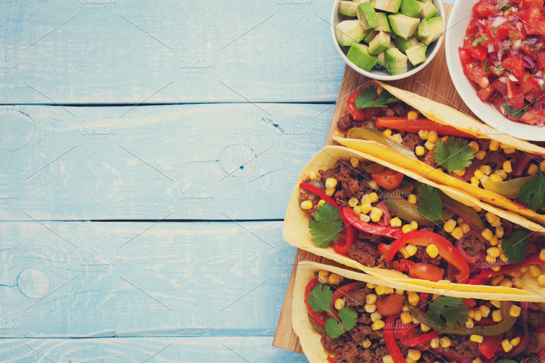 Mexican tacos with minced beef, vegetables and salsa. Tacos al pastor on wooden blue rustic background. Top view with copy space, a Food & Drink Photo by Budarinphoto