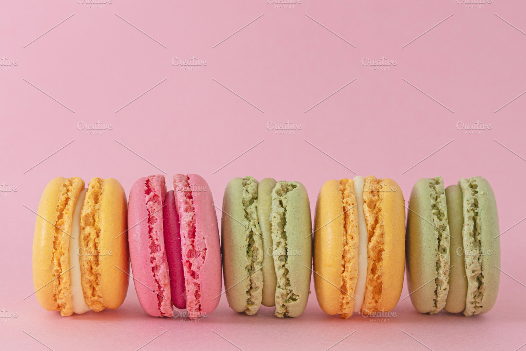 Pastel macarons on pink background, a Food & Drink Photo by Bloomstock studio
