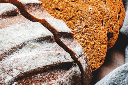 Rye sourdough bread with raisins, sliced pieces on wooden cuttin, a Food & Drink Photo by 5PH