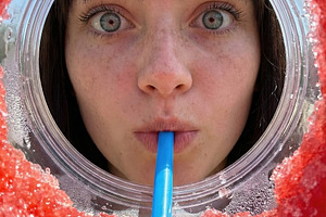 Playful Woman Drinking Red Slushie, a Person Photo by Virgo Studio