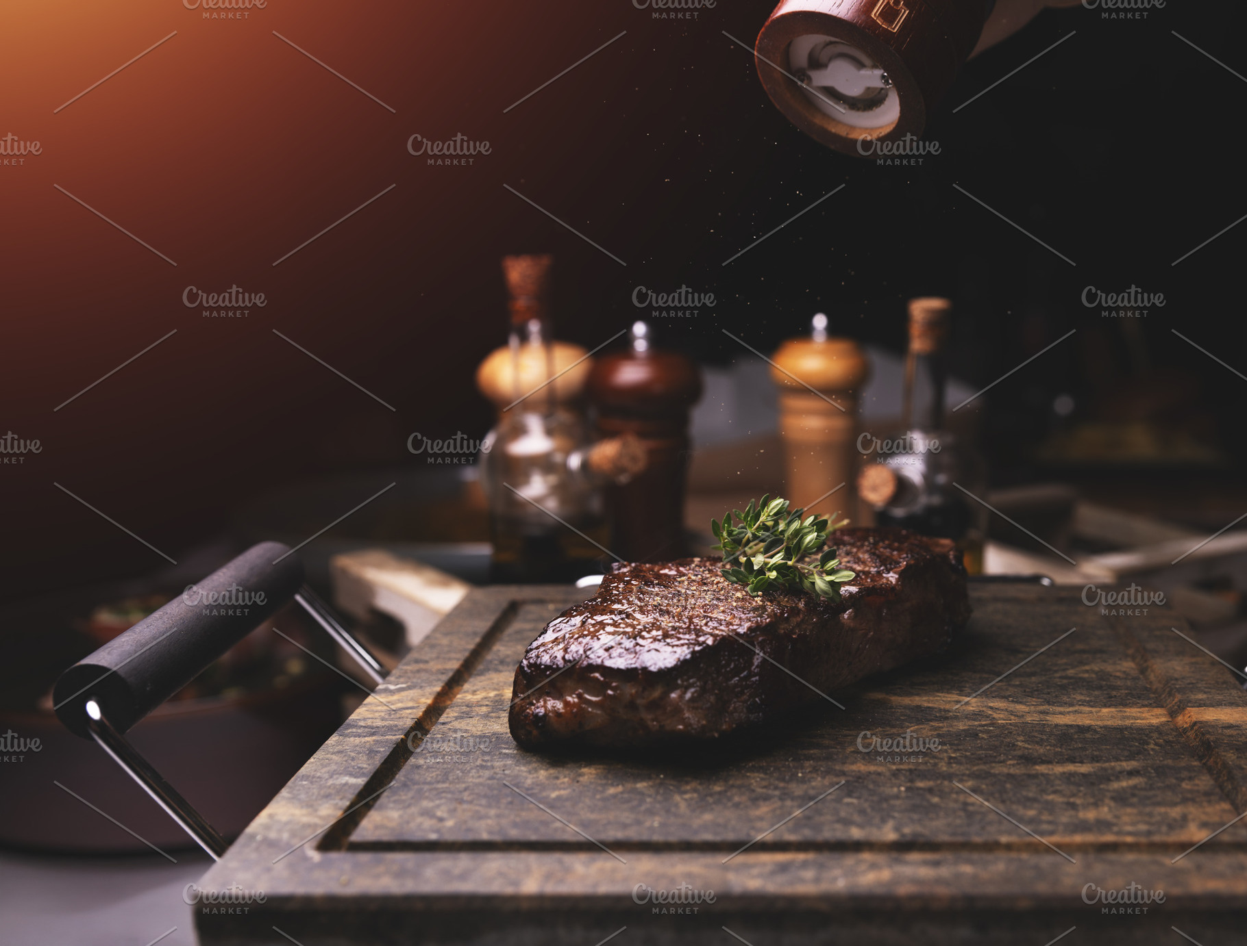 Chef adding salt and thyme to grilled steak, a Photo by Grafvision photography