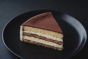 Delicious tiramisu cake slice, a Photo by Pavel_design