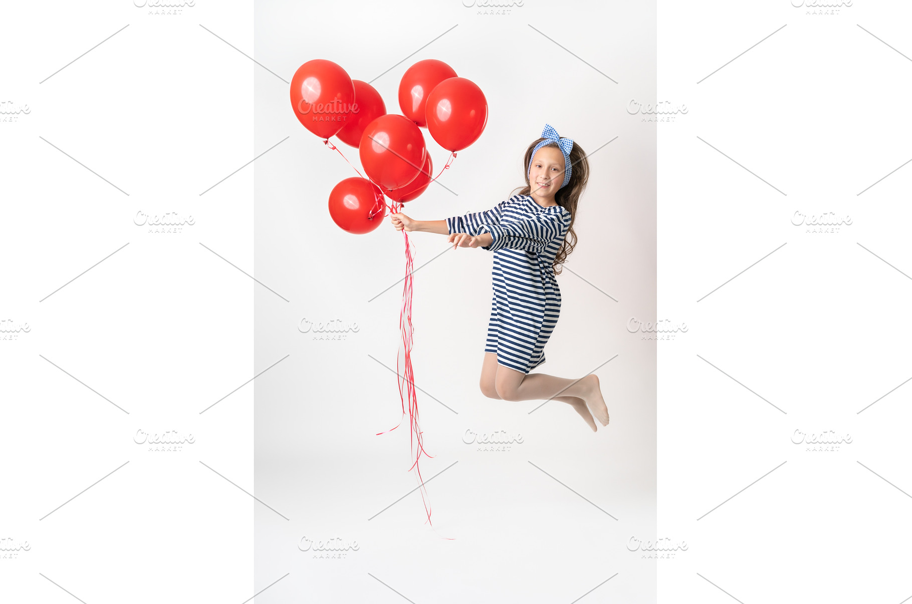 Girl in jump holding large bunch of, a Person Photo by Alexander-Piragis