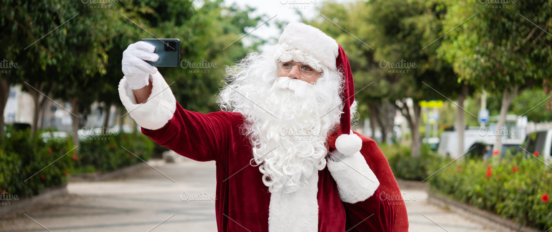 Santa Claus taking a selfie with smartphone outdoors, a Photo by etorres69