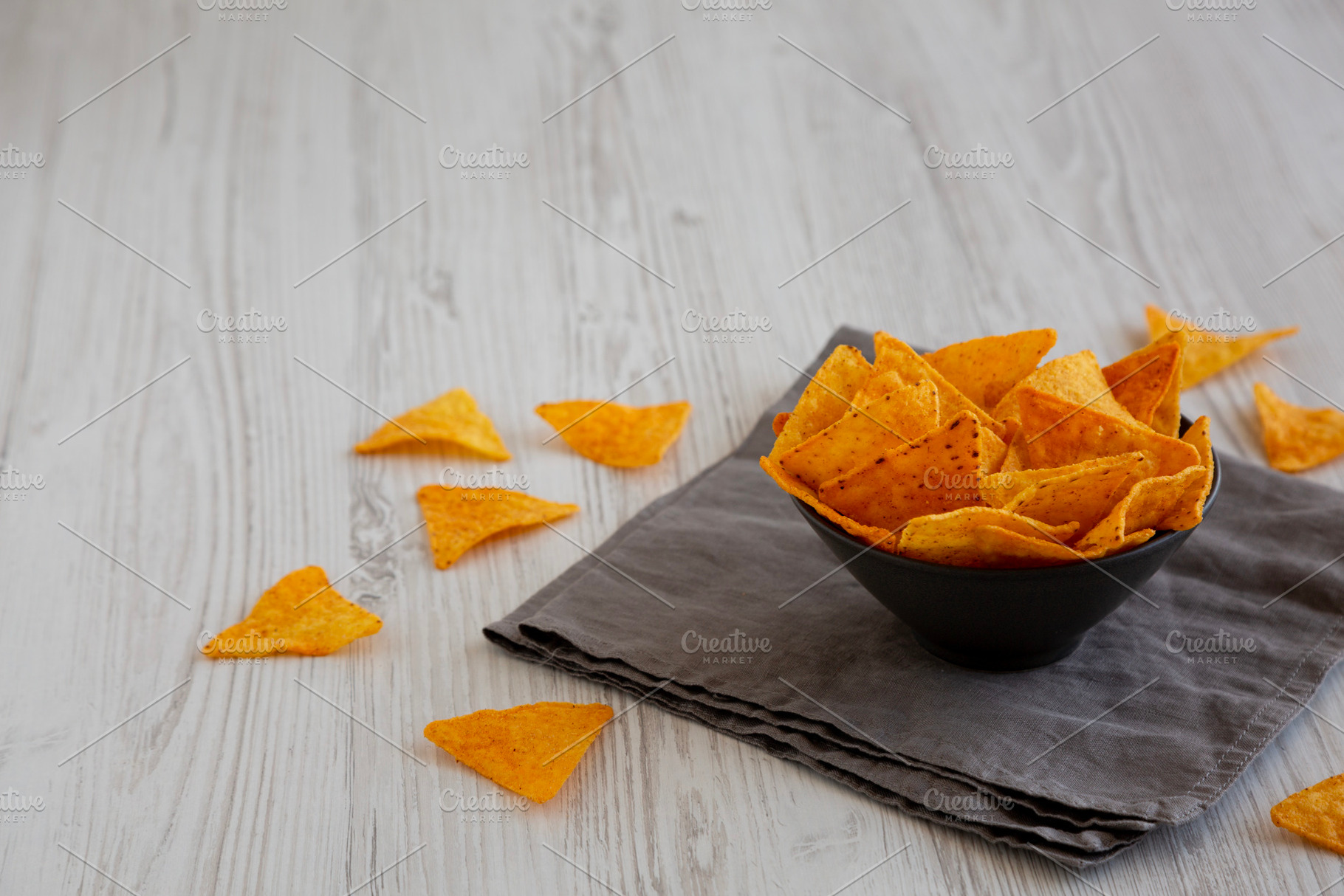 Crunchy Nacho BBQ Tortilla Chips in a Bowl, side view. Copy spac, a Food & Drink Photo by LiudmylaChuhunova