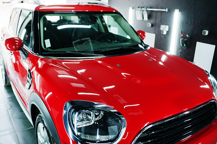 Headlights and hood of sport red car in garage., a Transportation Photo by AS photostudio