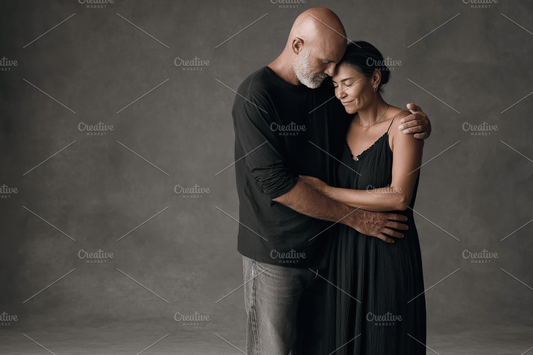 Couple embracing in a warm moment against a muted background in a studio settin, a Photo by AlyaAnd