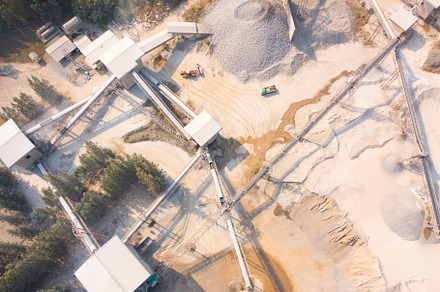Aerial view of machine excavator trucks dig coal mining or ore w, a Background Photo by Tampatra