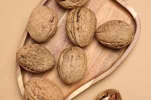 Walnut fruits on a brown background, close up, a Food & Drink Photo by ndanko