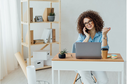 Young curly woman work on the, a Business Photo by Ksenia Neyman