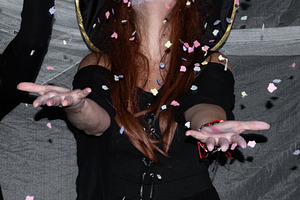 Woman dressed as witch celebrating Halloween party with confetti, a Person Photo by etorres69