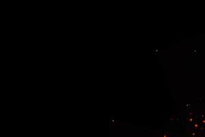 A circular frame of flames and sparks surrounding a dark circula, an Abstract Photo by ndanko