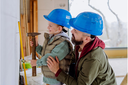 Father and his little son working on, a Person Photo by HalfPoint