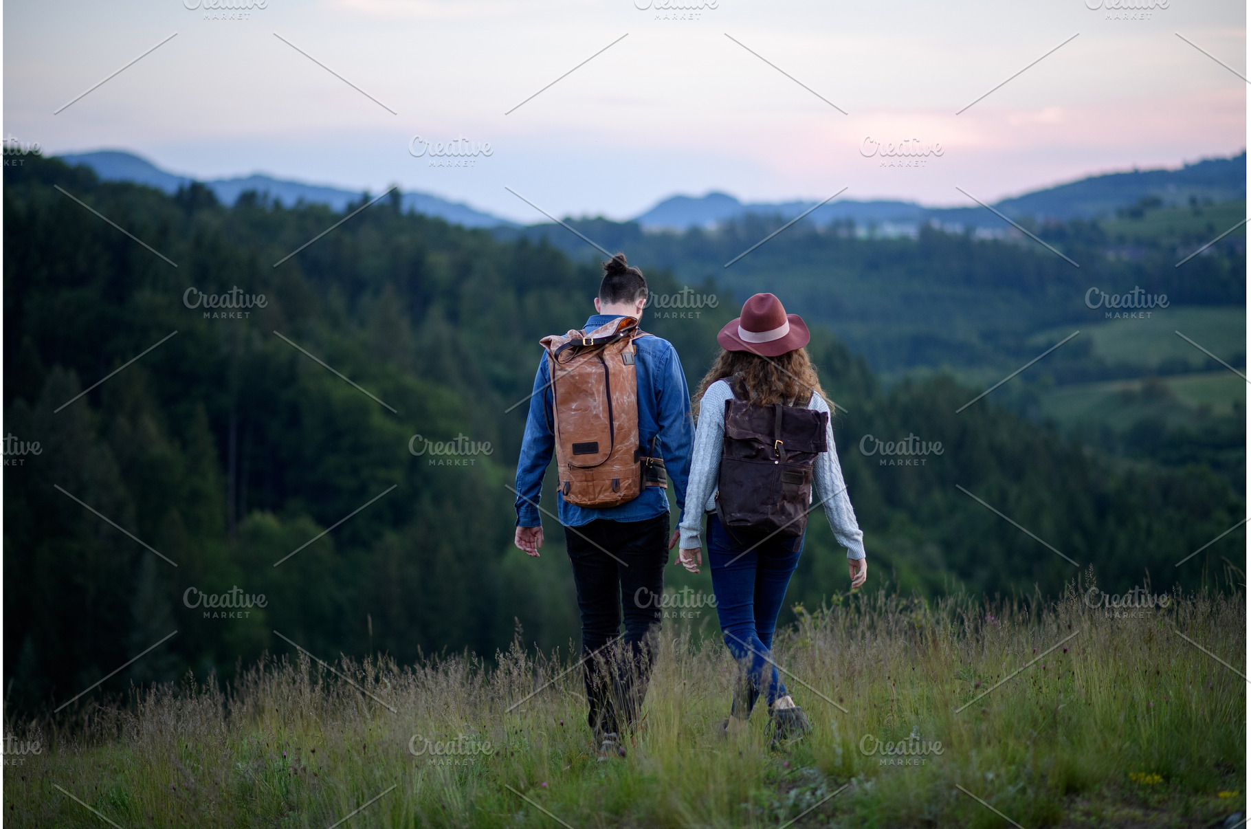 Travellers couple hiking on trail in, a Person Photo by HalfPoint