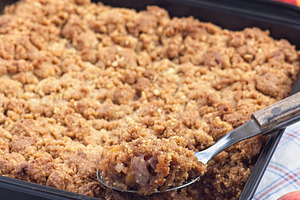 Peach Crisp or cobbler with brown sugar and oat streusel in backing dish, verti, a Food & Drink Photo by iuliia_n