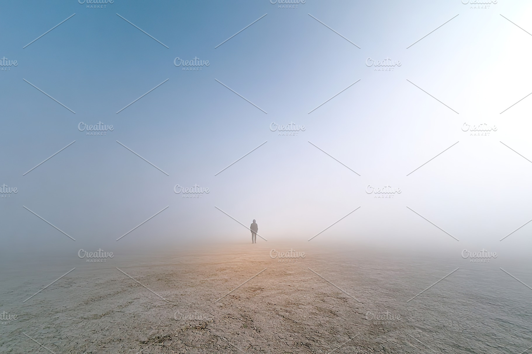 Solitary figure walking through a dense fog in an open, expansive landscape at, a Photo by AlyaAnd