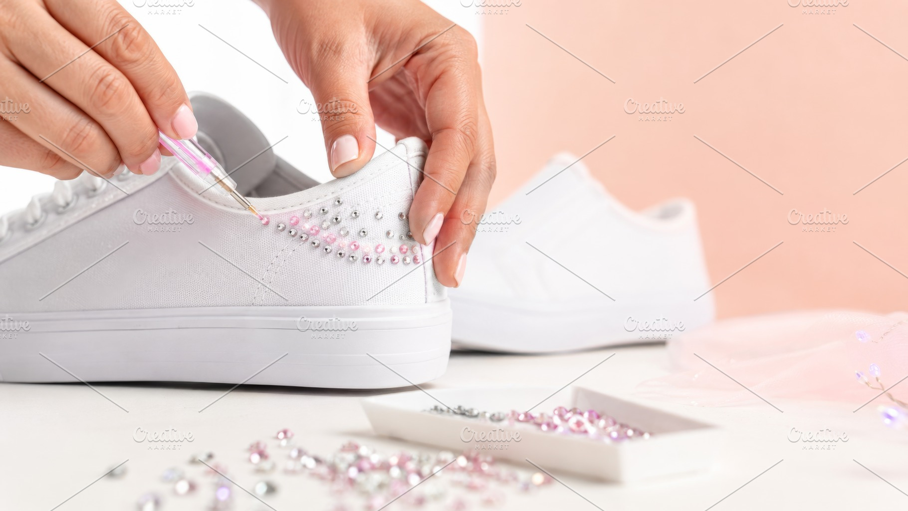 Bedazzling rhinestones on white snea, a Photo by Dvoevnore photos