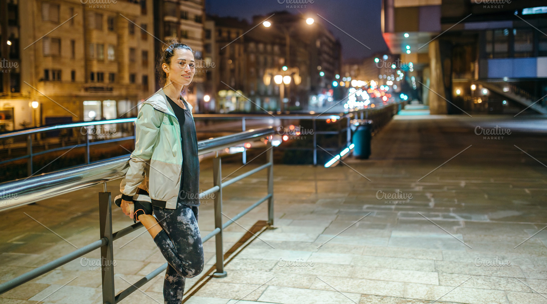 Woman runner stretching her legs next to banister before trainin, a Sports & Recreation Photo by davidpereiras