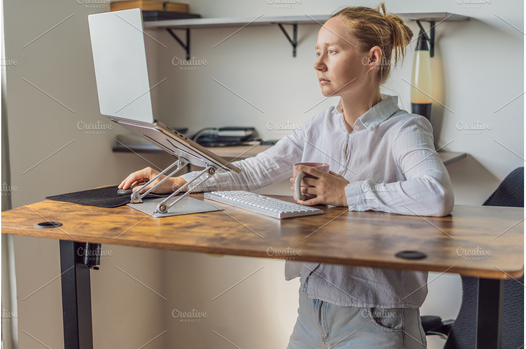 Woman standing at her desk and, a Technology Photo by Elizaveta Galitskaya