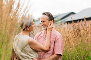 Aged romantic couple on a field, a Person Photo by Artem Varnitsin