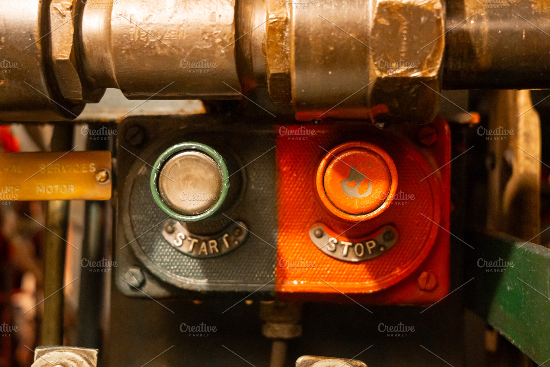 Start and stop buttons inside an old military submarine control, an Architecture Photo by GoodGoods