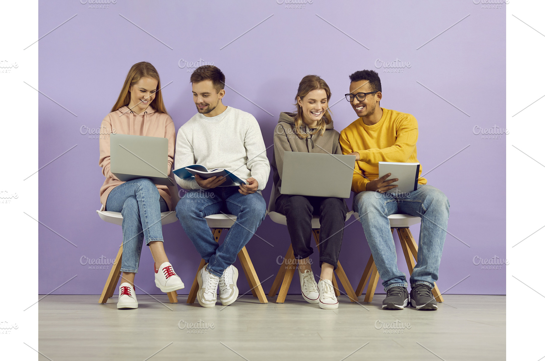 Students sitting in row on purple, a School & Education Photo by StudioRomantic