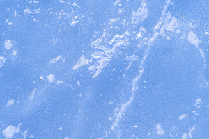 Blue rough ice texture with snow, winter background