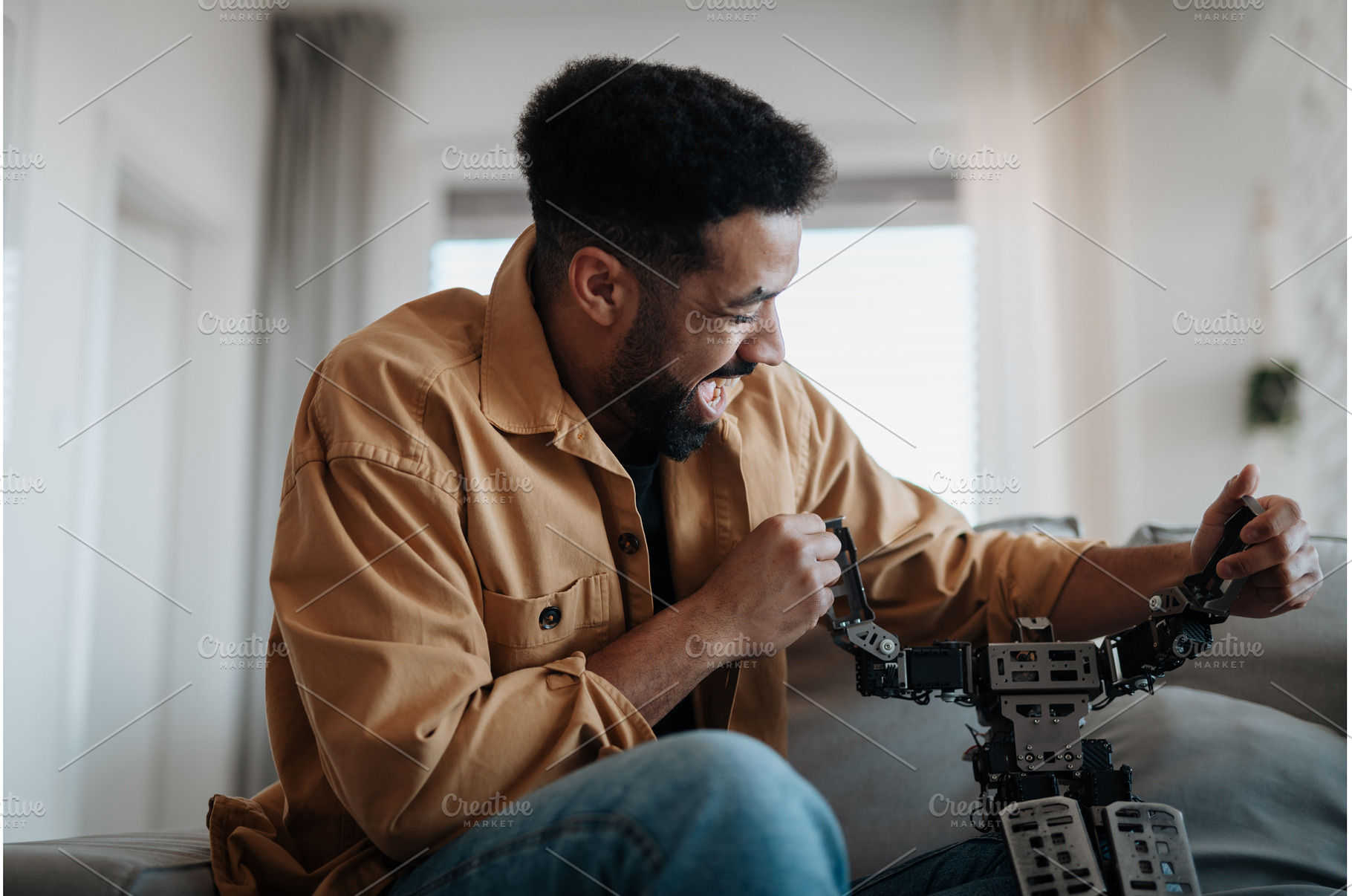Handsome man holding small robot and, a Technology Photo by HalfPoint