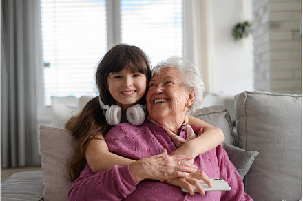 Cute girl hugging gradmother from, a Technology Photo by HalfPoint
