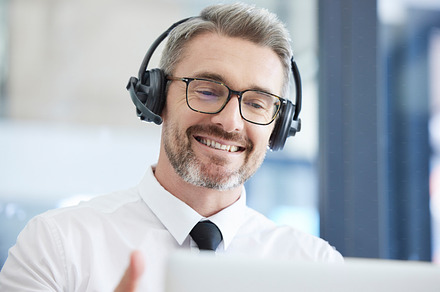 Call center, customer support and senior man talking to client in telemarketing, friendly service and crm company. Communication, contact us and male consulting agent with headset in customer service, a Photo by Peopleimages.com